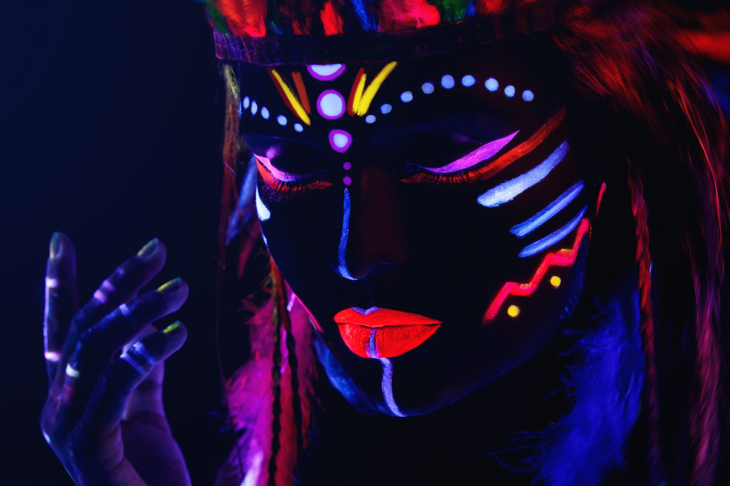 Woman with a UV paint in ultraviolet light